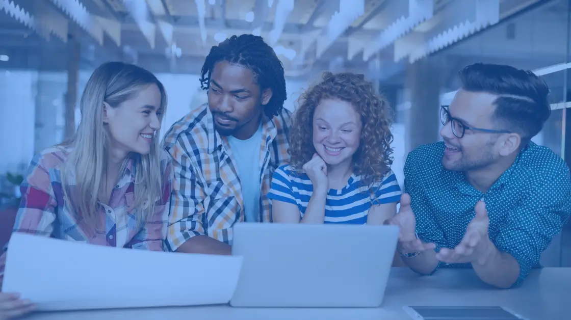 4 people looking at a computer