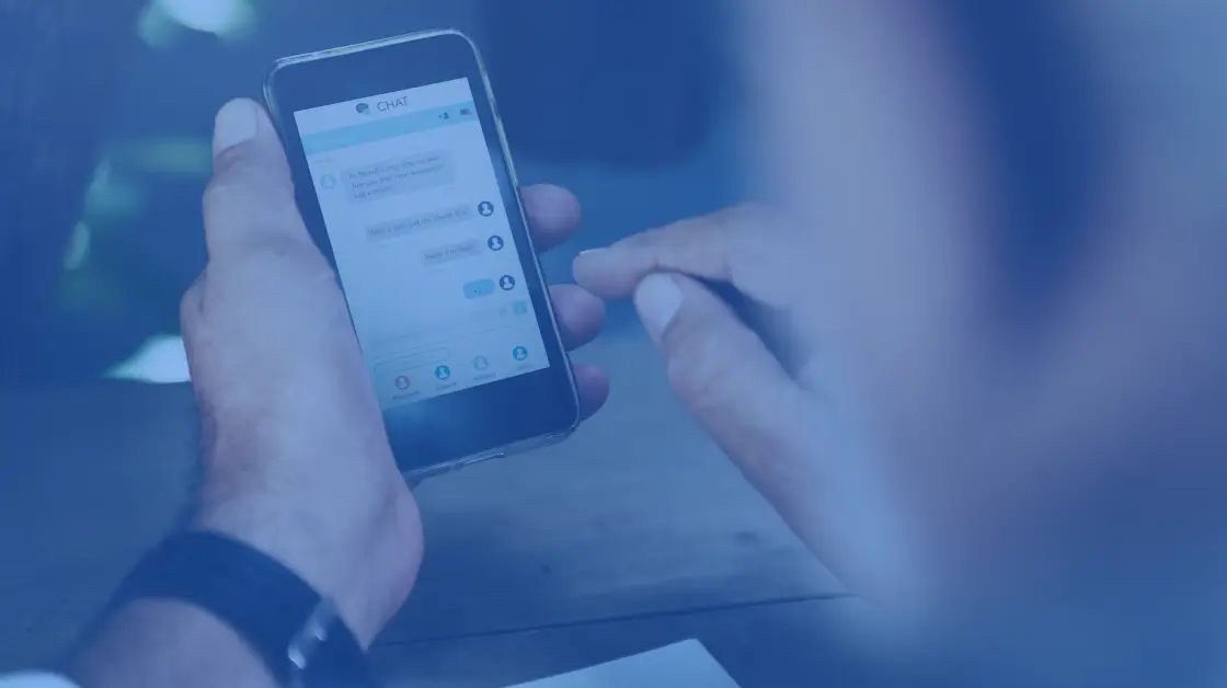 image of two hands holding phones texting